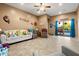 Open-concept living room leading to outdoor pool and patio, decorated with light colors at 21963 W Tonto St, Buckeye, AZ 85326