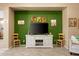 Cozy living room showcasing a green accent wall with TV and decor at 21963 W Tonto St, Buckeye, AZ 85326