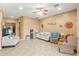Spacious living room with neutral decor, comfortable seating, and tile flooring throughout at 21963 W Tonto St, Buckeye, AZ 85326