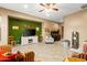 Warm, inviting living room with green accent wall, entertainment center, and comfortable seating arrangement at 21963 W Tonto St, Buckeye, AZ 85326