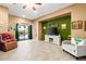 Bright living room featuring neutral walls, tile flooring, and sliding doors to outdoor pool at 21963 W Tonto St, Buckeye, AZ 85326