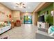 Bright living room with neutral tile, stylish furniture, and sliding glass doors leading to the pool area at 21963 W Tonto St, Buckeye, AZ 85326
