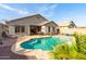 Inviting backyard pool with a covered patio and well-maintained landscaping for outdoor enjoyment at 21963 W Tonto St, Buckeye, AZ 85326