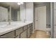 Bathroom featuring dual sinks, modern fixtures, and a neutral color palette at 22741 N Scott Dr, Maricopa, AZ 85138