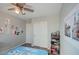 Bright bedroom featuring modern ceiling fan, closet, and decor on the wall at 22741 N Scott Dr, Maricopa, AZ 85138