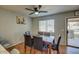 Cozy dining area with a granite-topped table, comfortable chairs, ceiling fan, and access to the patio at 22741 N Scott Dr, Maricopa, AZ 85138
