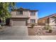 Beautiful two-story home with a well-manicured front yard and attached garage at 22741 N Scott Dr, Maricopa, AZ 85138
