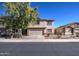 Well-maintained two-story home featuring a spacious driveway and desert landscaping at 22741 N Scott Dr, Maricopa, AZ 85138