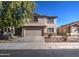 Two-story home with a well-manicured lawn and a two-car garage at 22741 N Scott Dr, Maricopa, AZ 85138
