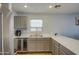 Modern kitchen with stainless steel appliances, a wine fridge, and abundant counter space at 22741 N Scott Dr, Maricopa, AZ 85138