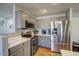 Modern kitchen with stainless steel appliances, quartz countertops, and gray cabinets at 22741 N Scott Dr, Maricopa, AZ 85138