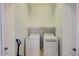 A conveniently located laundry room with modern, white, front-load washer and dryer at 22741 N Scott Dr, Maricopa, AZ 85138