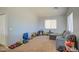 Bright living room featuring carpeted floors, gray walls and natural light at 22741 N Scott Dr, Maricopa, AZ 85138
