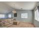 Open living room featuring neutral tones, sleek lighting and many windows at 22741 N Scott Dr, Maricopa, AZ 85138