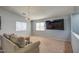 Cozy living room with TV, carpeted floors and natural light from windows at 22741 N Scott Dr, Maricopa, AZ 85138