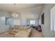 Spacious living room with modern lighting and comfortable sectional sofa at 22741 N Scott Dr, Maricopa, AZ 85138