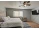 Modern bedroom with ceiling fan, natural light, and a wall-mounted TV at 22741 N Scott Dr, Maricopa, AZ 85138