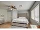 Bedroom with a ceiling fan, a large bed and dresser, providing lots of natural light at 22741 N Scott Dr, Maricopa, AZ 85138