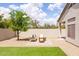 A backyard featuring a comfortable seating area, artificial lawn, and desert landscaping at 23046 N 88Th Way, Scottsdale, AZ 85255