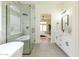 Sleek bathroom featuring a glass-enclosed shower, soaking tub, modern vanity, and neutral tiling at 23046 N 88Th Way, Scottsdale, AZ 85255