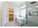 Modern bathroom featuring a freestanding tub, glass shower, and stylish fixtures; closet visible at 23046 N 88Th Way, Scottsdale, AZ 85255