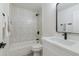 Well-lit bathroom featuring a tub/shower combination, elegant tile work, and a modern vanity at 23046 N 88Th Way, Scottsdale, AZ 85255