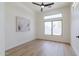 Bright bedroom with modern finishes, neutral paint, wood-look flooring, and a view of the desert landscape at 23046 N 88Th Way, Scottsdale, AZ 85255