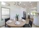 Bright dining area featuring a round table, modern chandelier, and seamless flow to the kitchen at 23046 N 88Th Way, Scottsdale, AZ 85255