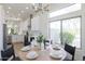 Stylish dining area with modern lighting fixture, great natural light, and bright finishes at 23046 N 88Th Way, Scottsdale, AZ 85255
