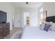 Bright main bedroom with walk-in closet, neutral decor, and light wood-look flooring at 23046 N 88Th Way, Scottsdale, AZ 85255