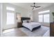 Serene main bedroom featuring a comfortable king bed, neutral decor, and ample natural light from large windows at 23046 N 88Th Way, Scottsdale, AZ 85255