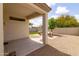 Covered patio features a comfortable seating area, artificial lawn, and desert landscaping at 23046 N 88Th Way, Scottsdale, AZ 85255