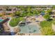Aerial view of park with basketball court, playground, and landscaped walking paths in a beautiful neighborhood setting at 2361 N 156Th Dr, Goodyear, AZ 85395