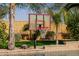 Backyard basketball hoop beside the pool, set in a lush garden environment with palm trees at 2361 N 156Th Dr, Goodyear, AZ 85395