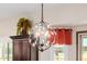 Decorative chandelier adds a touch of elegance to the open-concept kitchen and living space at 2361 N 156Th Dr, Goodyear, AZ 85395