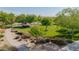 Well-maintained community park with playground, mature trees, landscaped desert, and walking path at 2361 N 156Th Dr, Goodyear, AZ 85395