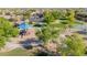 A charming park offers a playground with shade, lush trees, manicured lawns, and walking paths at 2361 N 156Th Dr, Goodyear, AZ 85395