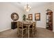 Inviting dining room featuring neutral walls, carpet, and a stylish light fixture above the table at 2361 N 156Th Dr, Goodyear, AZ 85395