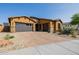 A spacious three car driveway leads to this home's well-manicured and xeriscaped front yard at 2361 N 156Th Dr, Goodyear, AZ 85395