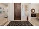 Inviting foyer with decorative rug, dark wood front door, and neutral walls at 2361 N 156Th Dr, Goodyear, AZ 85395