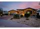 Inviting home with brick accents, desert landscaping, a driveway, and a two-car garage at 2361 N 156Th Dr, Goodyear, AZ 85395