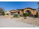 Inviting home with stone accents, neat landscaping, a driveway, and a two-car garage at 2361 N 156Th Dr, Goodyear, AZ 85395