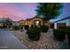 Charming single-story home featuring desert landscaping, warm exterior paint, and attached garage at 2361 N 156Th Dr, Goodyear, AZ 85395
