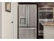 Stainless steel refrigerator and oven appliances provide a modern, luxury feel in the kitchen at 2361 N 156Th Dr, Goodyear, AZ 85395