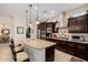 Beautiful kitchen with dark wood cabinetry, granite countertops, and stainless steel appliances at 2361 N 156Th Dr, Goodyear, AZ 85395