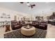 Open-concept living room connected to kitchen, featuring a large sectional sofa and stylish decor at 2361 N 156Th Dr, Goodyear, AZ 85395