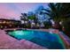 Inviting pool with a waterfall feature, bar stool seating, and lush landscaping at 2361 N 156Th Dr, Goodyear, AZ 85395