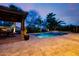 Sparkling pool featuring a travertine patio, poolside pergola, and lush landscaping for a resort-like feel at 2361 N 156Th Dr, Goodyear, AZ 85395