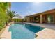 Sparkling backyard pool with basketball hoop and covered patio, perfect for outdoor entertaining and relaxation at 2361 N 156Th Dr, Goodyear, AZ 85395