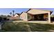 Expansive backyard featuring a covered patio and lush green grass at 241 W Atlantic Dr, Casa Grande, AZ 85122